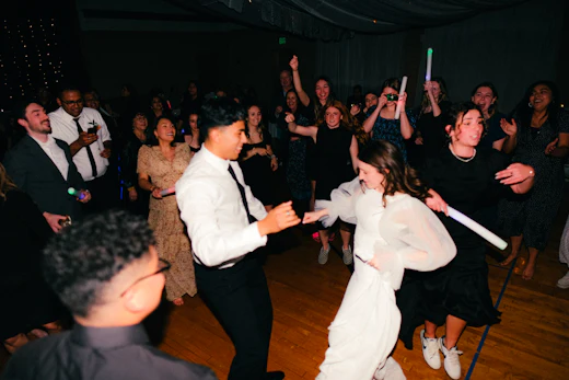 Two people dancing on a crowded floor