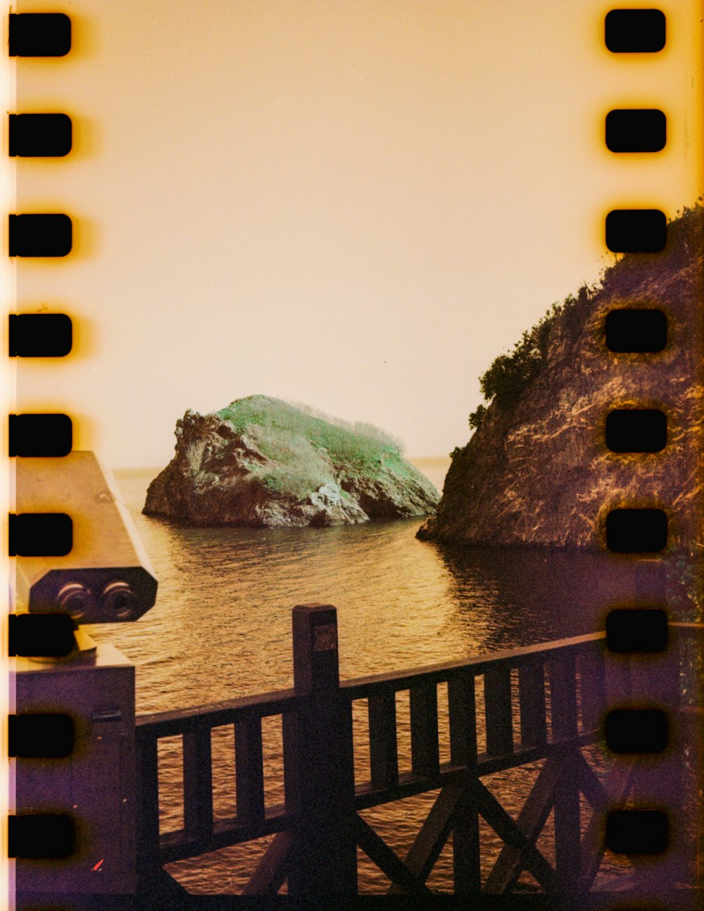 a polaroid photo of a rock in the water