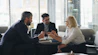 a group of people sitting around a table