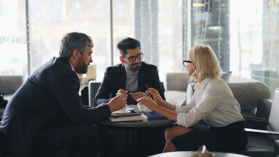 a group of people sitting around a table,
