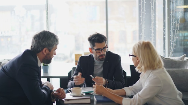 a group of people sitting around a table