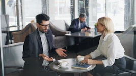 a man and a woman sitting at a table talking