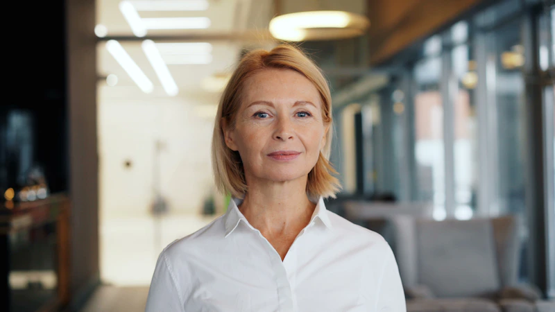 a woman in a white shirt standing in a room