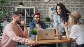 a group of people sitting around a wooden table