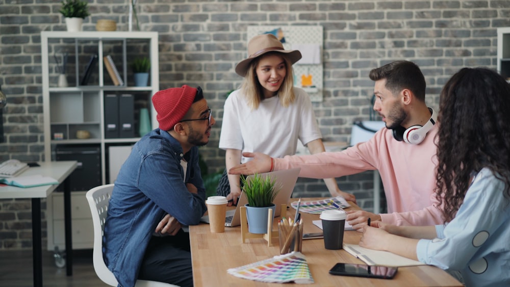 a group of people sitting around a wooden table