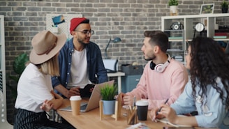 a group of people sitting around a wooden table