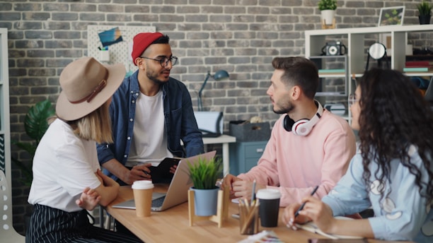 a group of people sitting around a wooden table