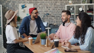 a group of people sitting around a wooden table