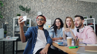 a group of people sitting around a wooden table