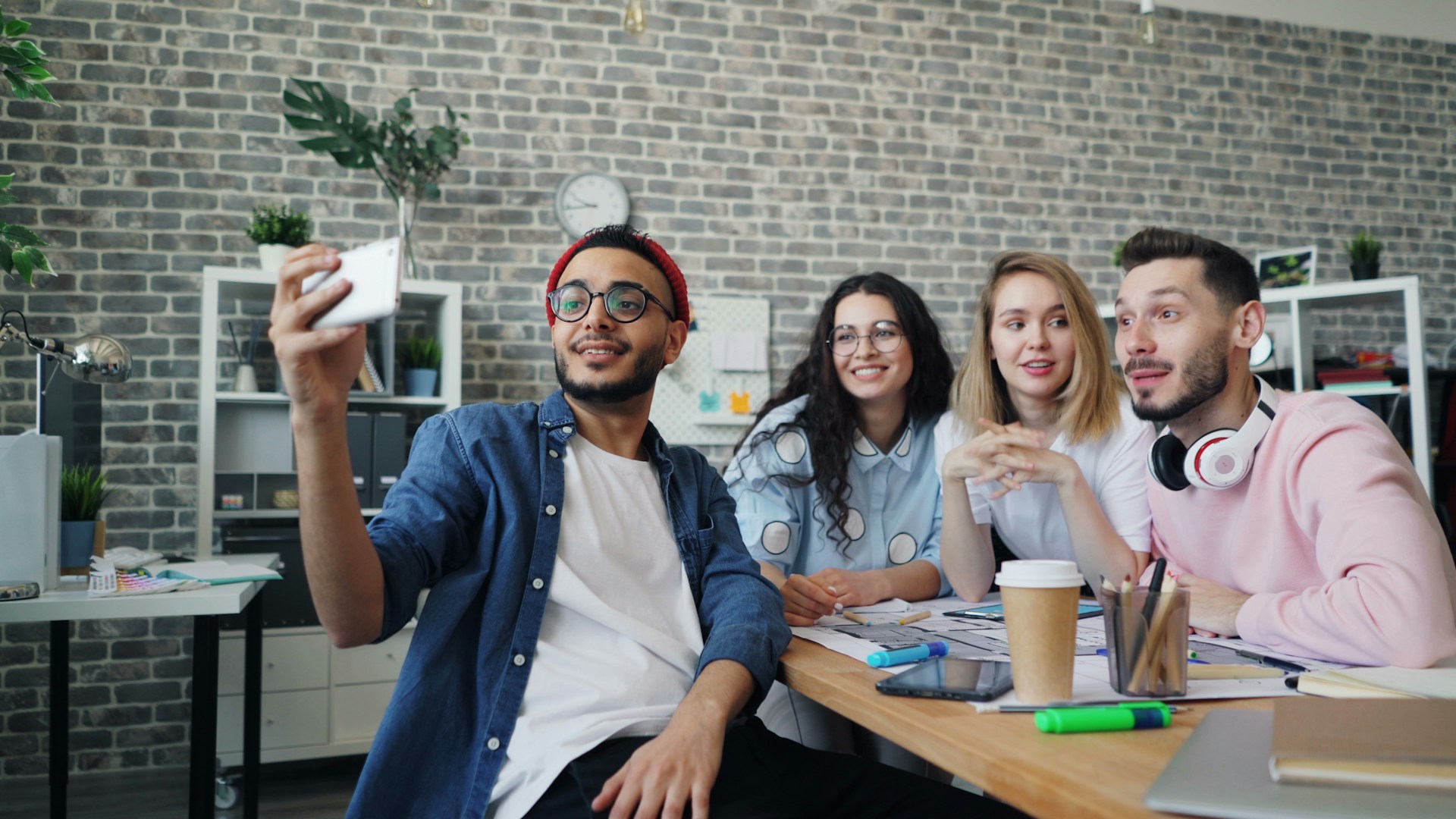 a group of people sitting around a wooden table