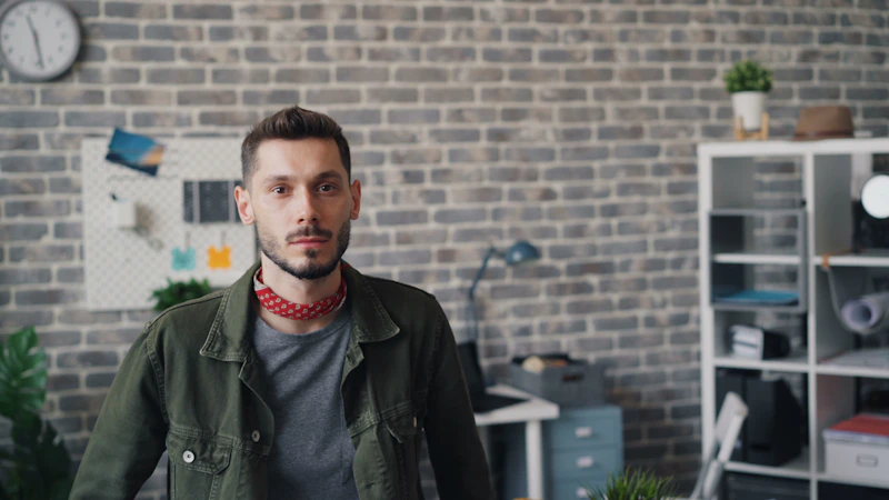 a man standing in front of a brick wall