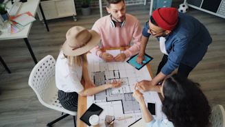 a group of people sitting around a table playing a board game