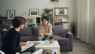 two people sitting on a couch in a living room