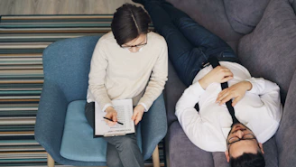a man and a woman sitting on a couch next to each other