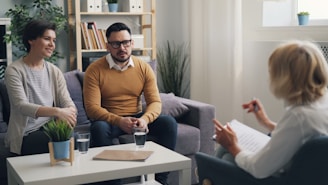 a man and woman sitting on a couch talking to each other