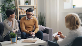 a group of people sitting around a living room
