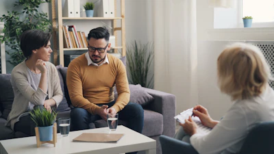 a group of people sitting around a living room