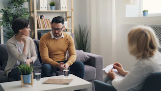 a group of people sitting around a living room