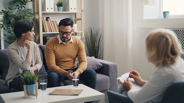 a group of people sitting around a living room