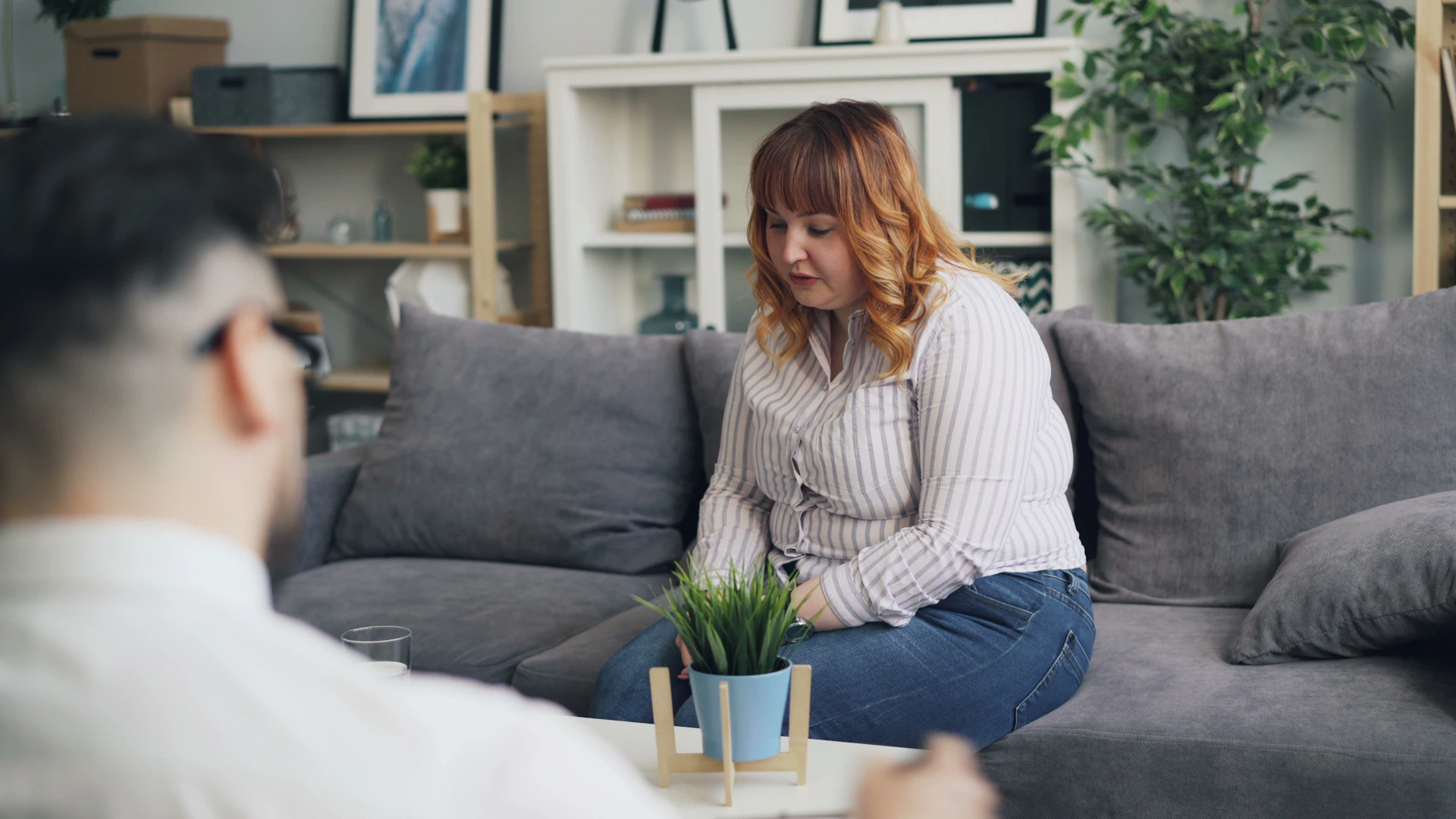 a woman sitting on top of a couch next to a man