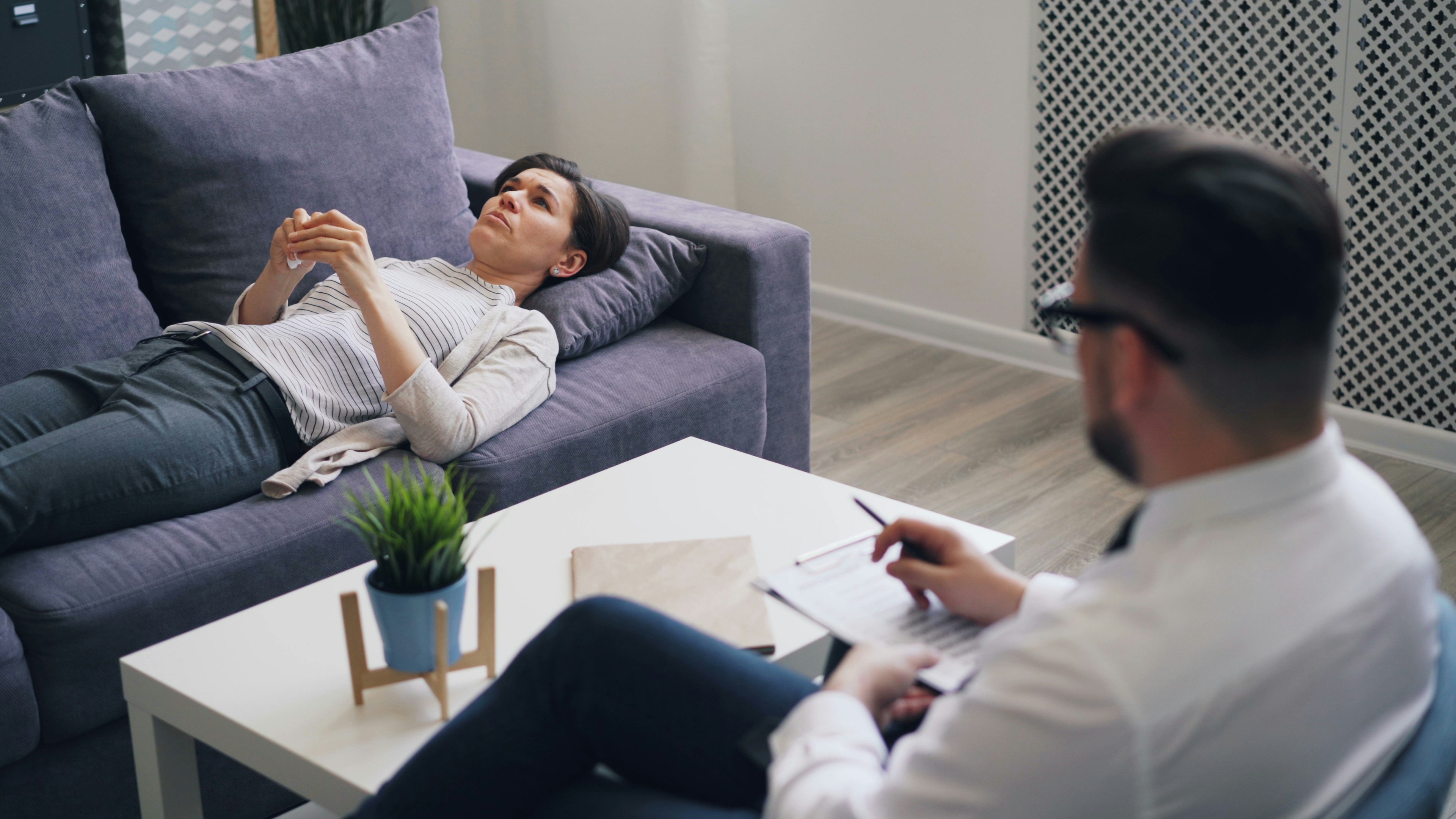 a man sitting on a couch next to a woman