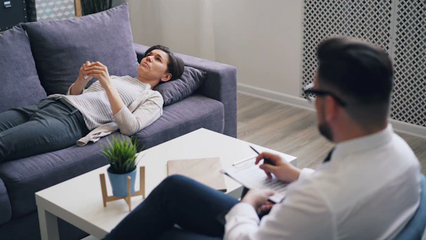 a man sitting on a couch next to a woman