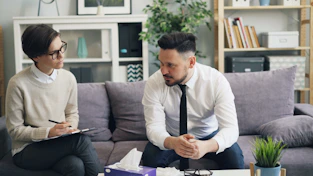 a man and a woman sitting on a couch