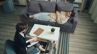a man and woman sitting on a couch in a living room