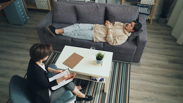 a man and woman sitting on a couch in a living room