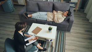 a man and woman sitting on a couch in a living room