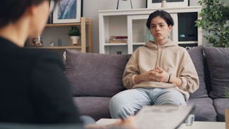a woman sitting on a couch in a living room