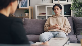 a woman sitting on a couch in a living room