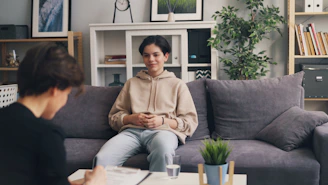 a woman sitting on a couch in a living room
