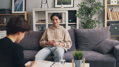 a woman sitting on a couch in a living room
