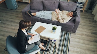 a man and woman sitting on a couch in a living room
