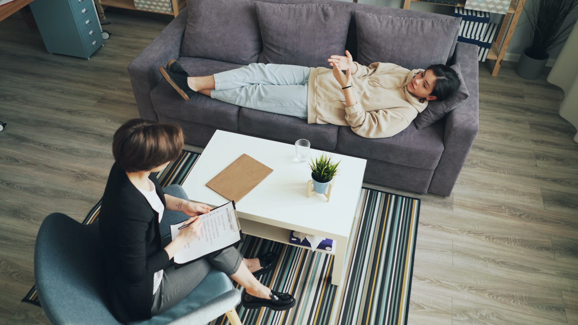 a man and woman sitting on a couch in a living room