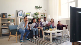 a group of people sitting around a living room together