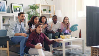 a group of people sitting on a couch in a living room