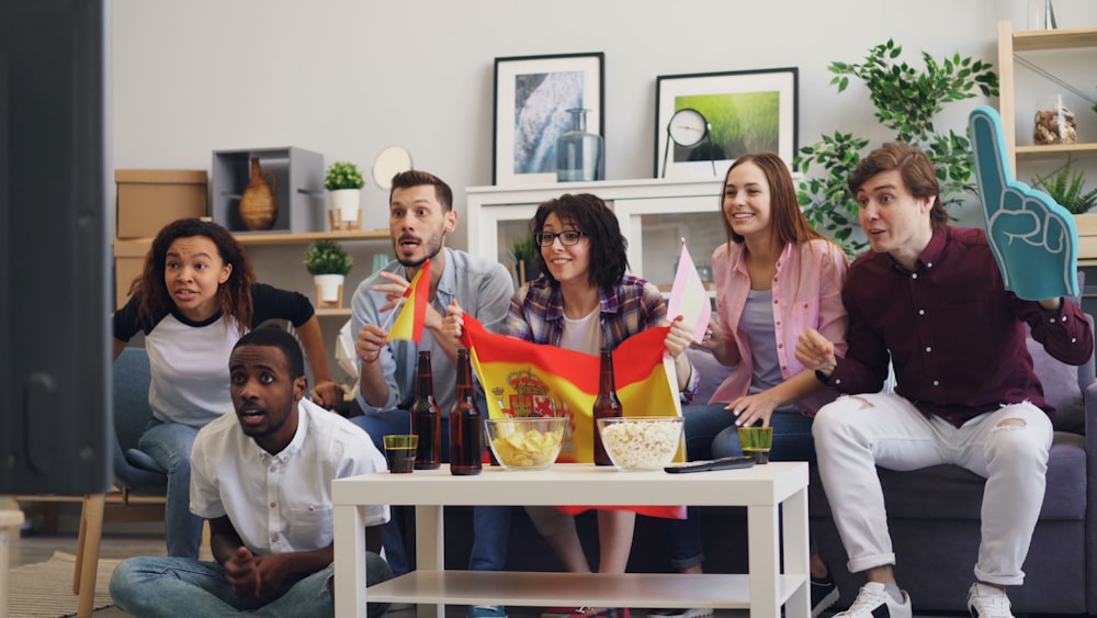 a group of people sitting on a couch in a living room