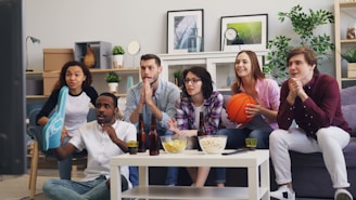 a group of people sitting on a couch in a living room