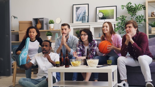 a group of people sitting on a couch in a living room