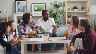 a group of people sitting on a couch talking