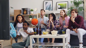a group of people sitting around a living room