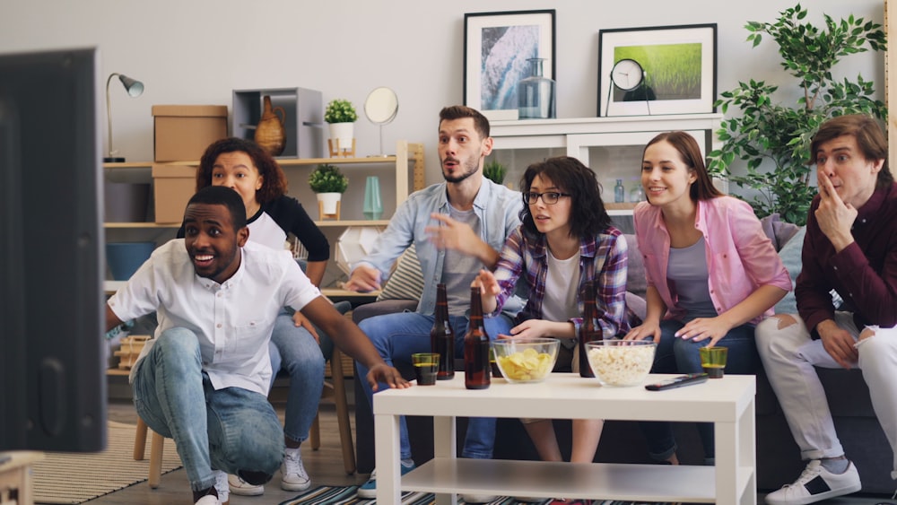 a group of people sitting around a television