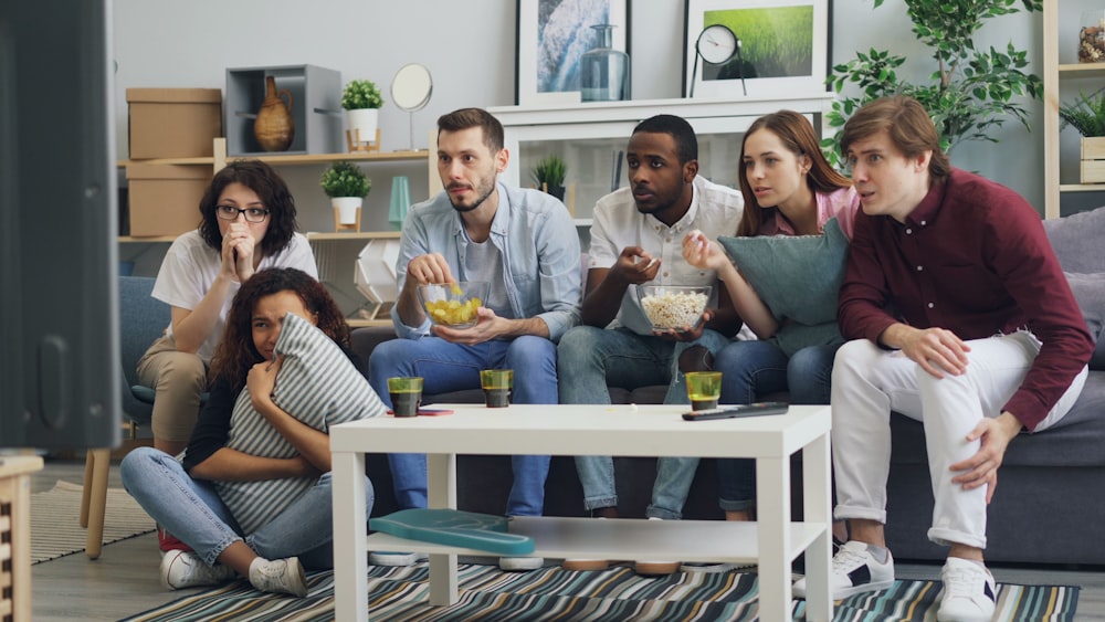 a group of people sitting on a couch in a living room