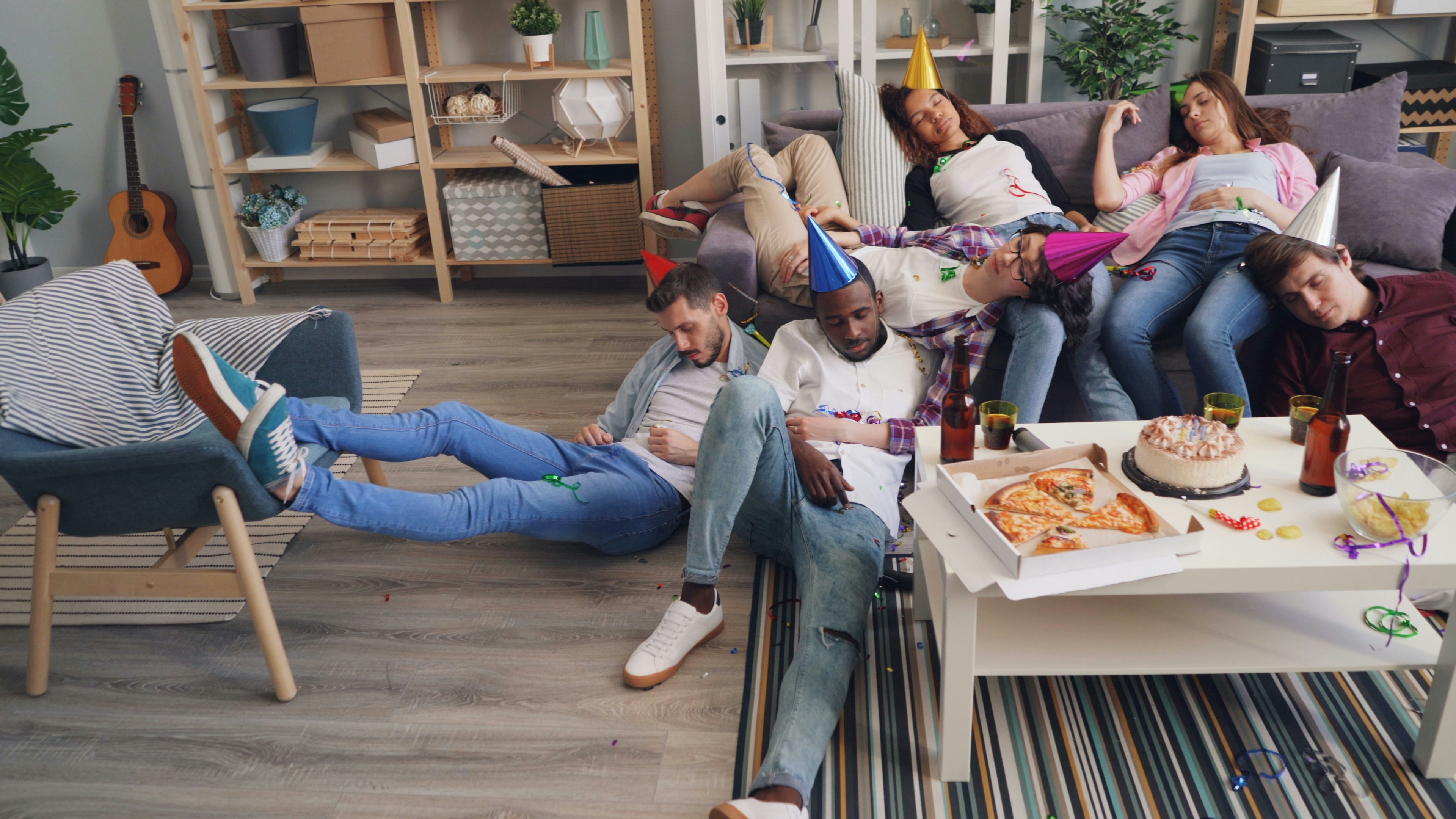 A group of people sitting on a couch in a living room photo – Free Grey ...