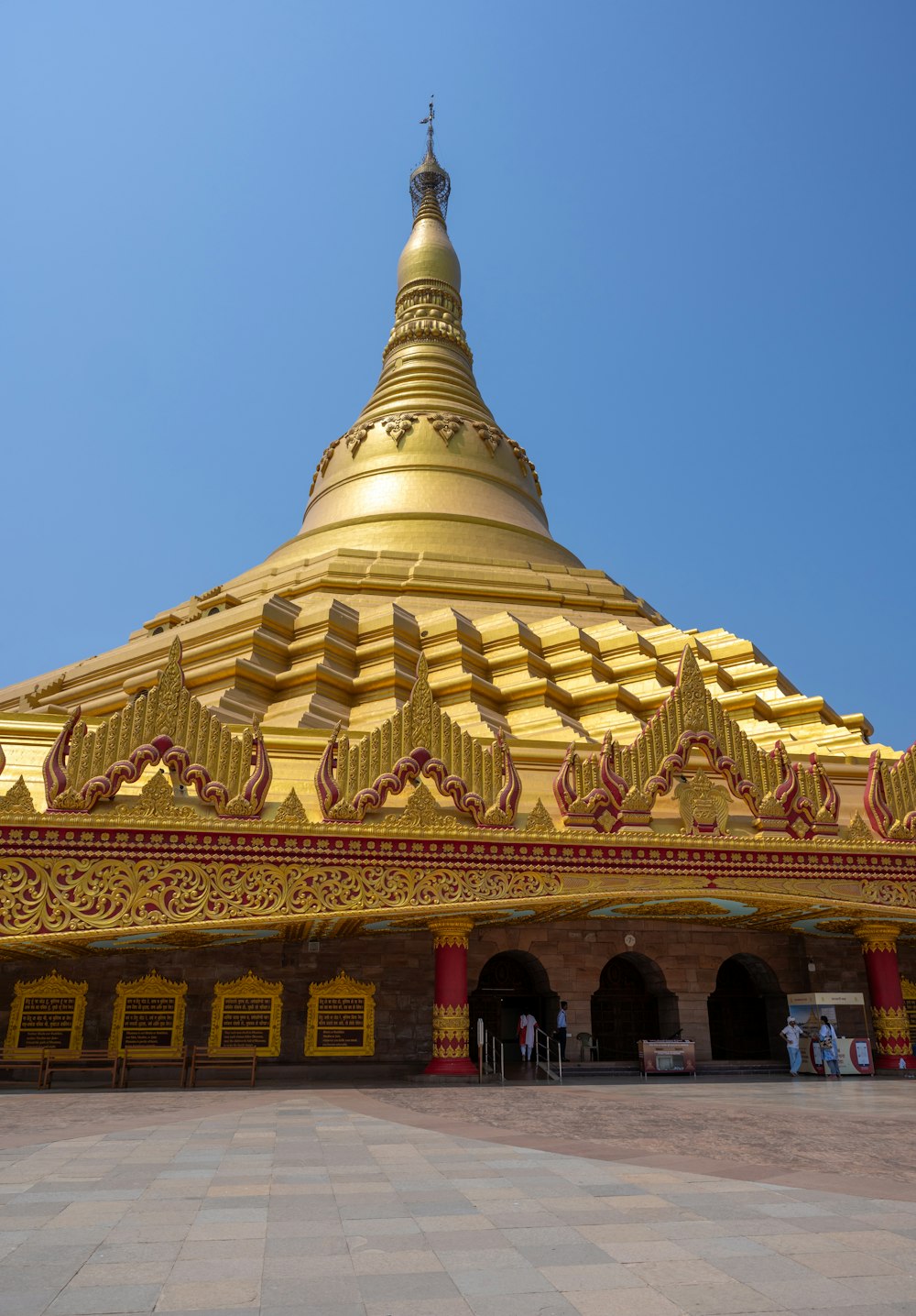 a large golden building with a sky in the background