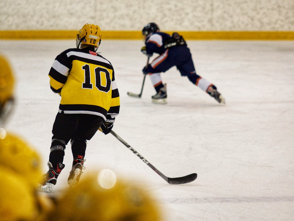 a group of young men playing a game of ice hockey