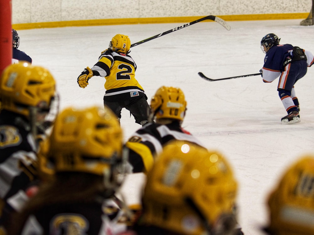 a group of young men playing a game of ice hockey