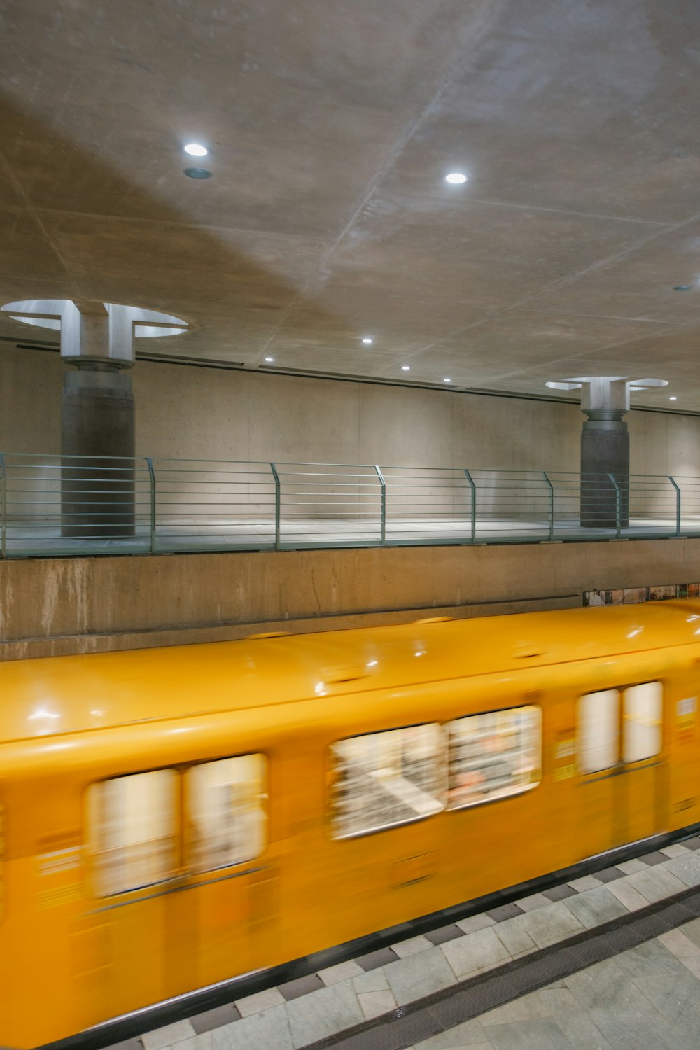 a yellow train traveling through a train station